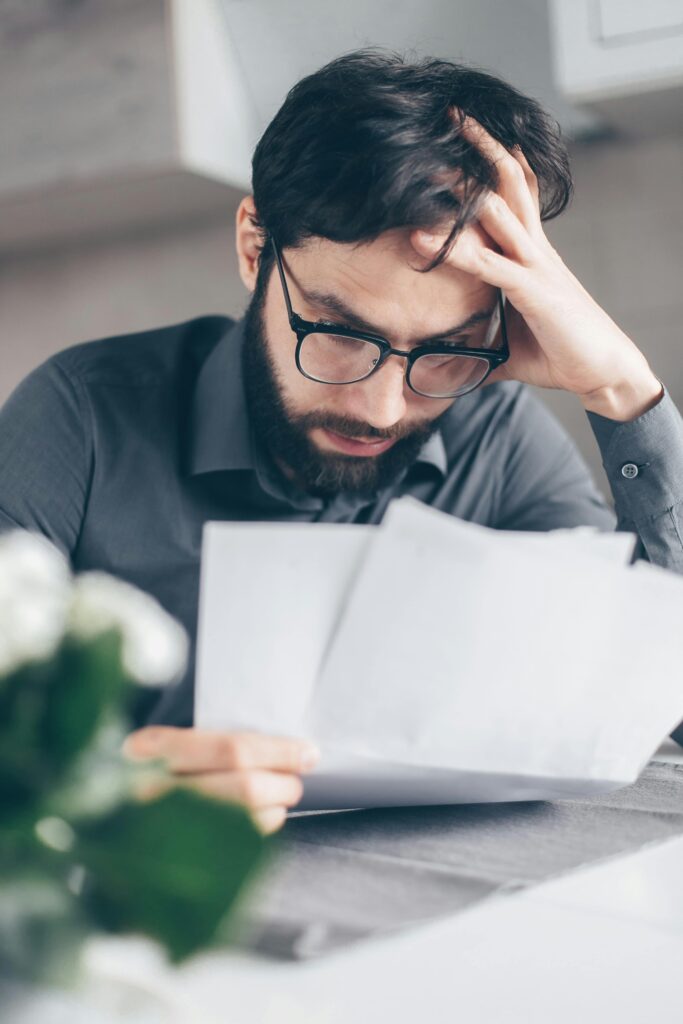 pexels-photo-7534773-7534773 Man in Black Long Sleeve Shirt Holding White Papers